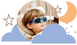 Child relaxing in dental chair during pediatric dental procedure