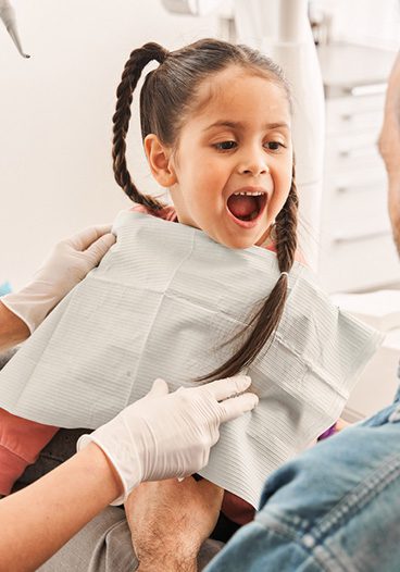 Young patient being examined during pediatric dental emergency visit